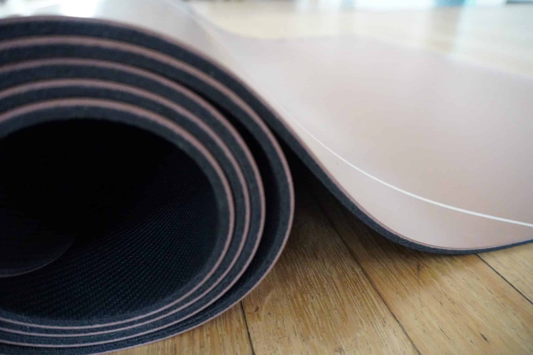 the nile natural rubber & pu yoga mat (5mm non slip grip) Rolled Nile yoga mat on floor
