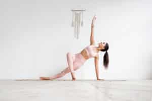 The Many Ways We Practise Yoga young attractive woman practicing yoga in bright yoga class on w
